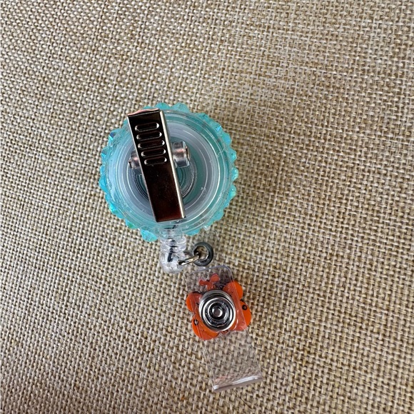 Smiling Daisy Glitter Badge Reel with Orange Butterfly Charm - Picture 3 of 4